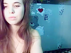 Sexy little brunette is on her live webcam chatting and sho